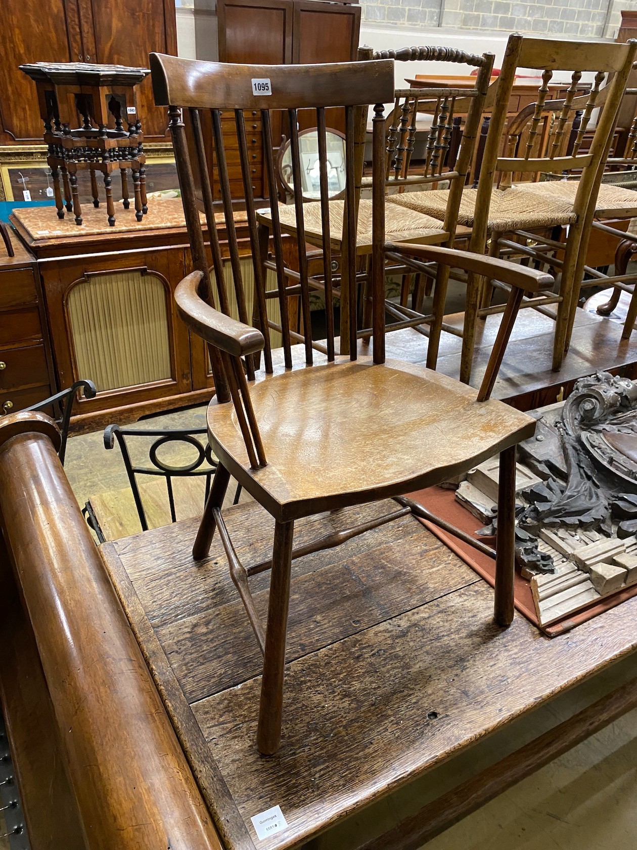 An early 20th century beech Windsor comb back elbow chair, width 49cm, depth 41cm, height 86cm